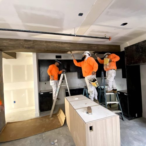 Construction crew painting interior commercial space